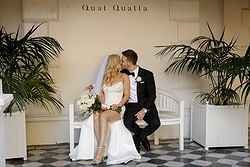 Traditional Luxe Wedding Quat Quatta bride + Groom seated kissing under the verandah